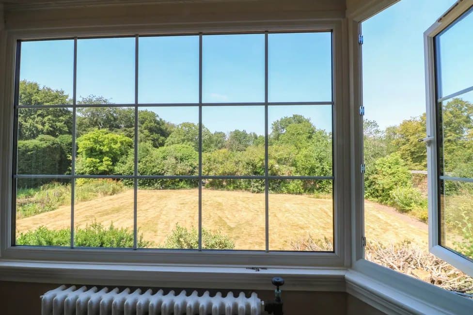 The view from the bay window, over hedges and open fields